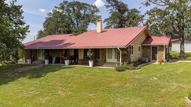 20700 E 420th Rd, Claremore, OK 74017 - back of property with stone siding, a lawn, a chimney, and a metal roof