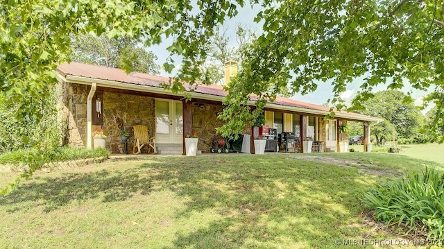 20700 E 420th Rd, Claremore, OK 74017 - view of front facade with stone siding, a front lawn, and a chimney