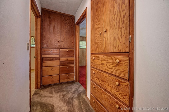 506 S 8th, Davis, OK 73030 - corridor featuring dark colored carpet, a textured ceiling, and a textured wall