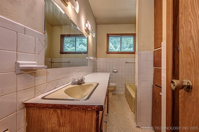 506 S 8th, Davis, OK 73030 - bathroom with tile walls, vanity, a bath, toilet, and wainscoting