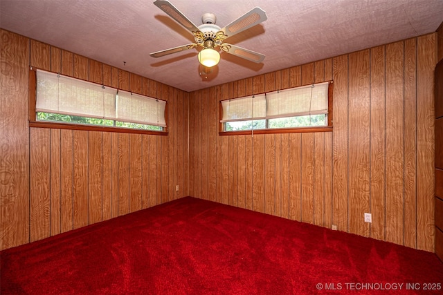 506 S 8th, Davis, OK 73030 - carpeted empty room with wood walls and ceiling fan
