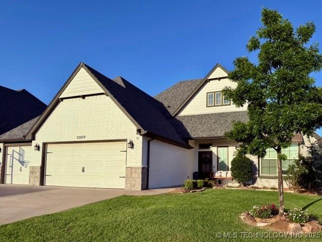 13019 S 5th Pl, Jenks, OK 74037 - view of front of property with a garage, a front lawn, concrete driveway, a shingled roof, and brick siding