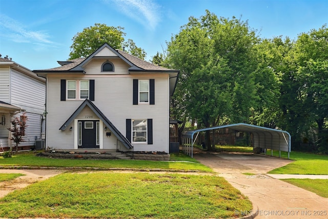 1206 S Osage Ave, Bartlesville, OK 74003 - view of front facade featuring a front lawn, a detached carport, driveway, and central AC