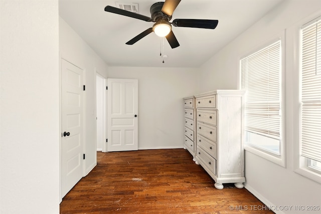 1206 S Osage Ave, Bartlesville, OK 74003 - unfurnished bedroom with dark wood-type flooring, ceiling fan, and baseboards