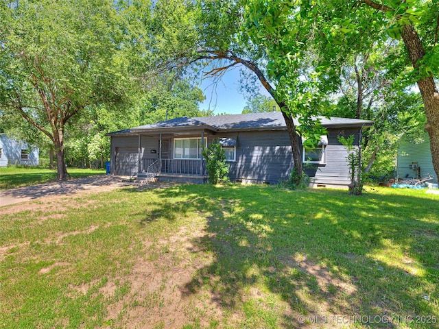 2409 N Urbana Ave, Tulsa, OK 74115 - view of front of house featuring an attached garage, driveway, and a front lawn