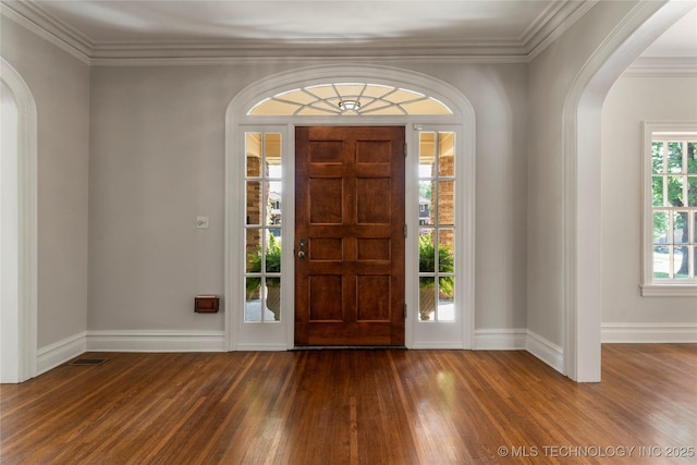 1217 Hazel Blvd, Tulsa, OK 74114 - entryway featuring arched walkways, dark wood-type flooring, baseboards, and crown molding