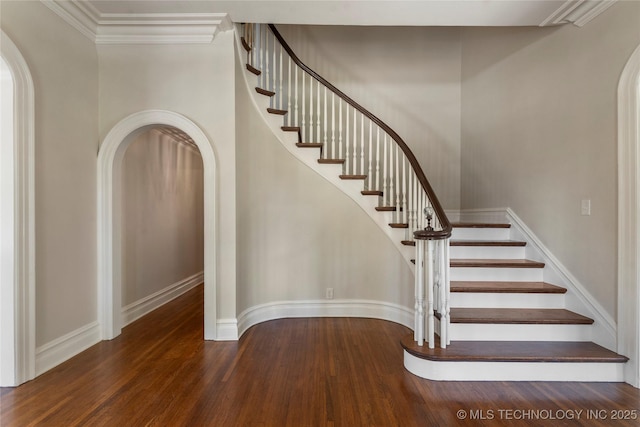 1217 Hazel Blvd, Tulsa, OK 74114 - stairway featuring arched walkways, wood finished floors, baseboards, and ornamental molding