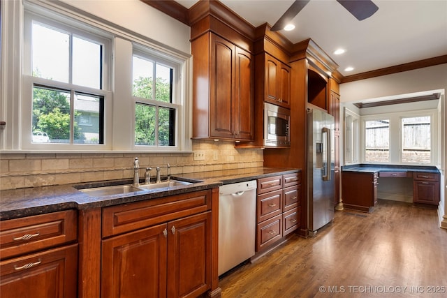 1217 Hazel Blvd, Tulsa, OK 74114 - kitchen with appliances with stainless steel finishes, a sink, dark wood finished floors, ornamental molding, and tasteful backsplash