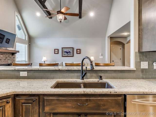 7605 E 82nd Pl, Owasso, OK 74055 - kitchen with a sink, dishwasher, backsplash, a ceiling fan, and light stone counters