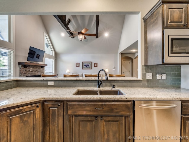 7605 E 82nd Pl, Owasso, OK 74055 - kitchen with stainless steel appliances, ceiling fan, a sink, tasteful backsplash, and light stone countertops