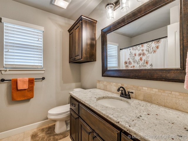 7605 E 82nd Pl, Owasso, OK 74055 - bathroom featuring vanity, toilet, baseboards, and healthy amount of natural light