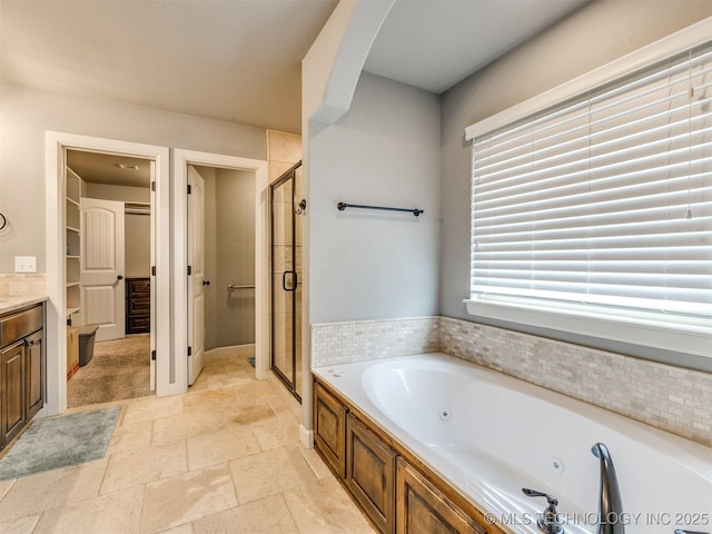7605 E 82nd Pl, Owasso, OK 74055 - bathroom with a stall shower, a tub with jets, vanity, and stone tile flooring