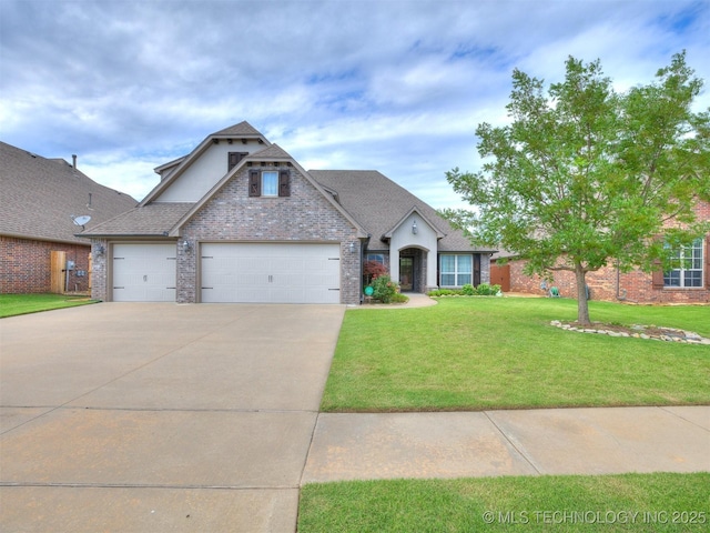 7605 E 82nd Pl, Owasso, OK 74055 - view of front of home with a front yard, driveway, brick siding, and a garage