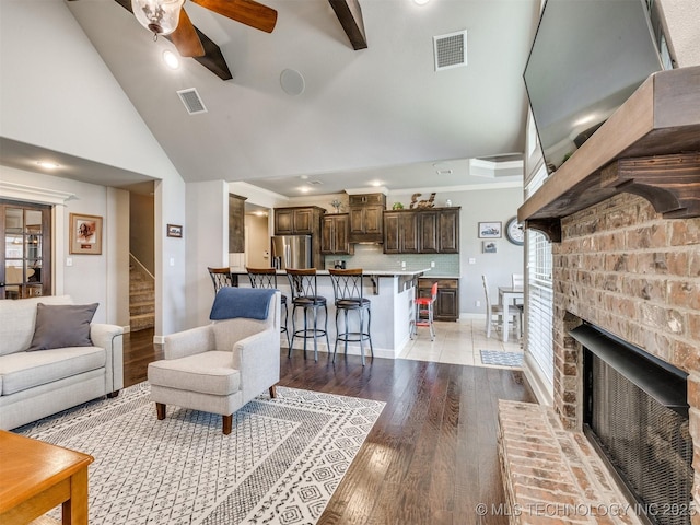 7605 E 82nd Pl, Owasso, OK 74055 - living area featuring a ceiling fan, high vaulted ceiling, stairway, light wood-style floors, and baseboards