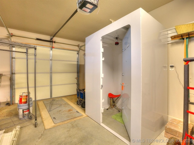 7605 E 82nd Pl, Owasso, OK 74055 - garage featuring a garage door opener
