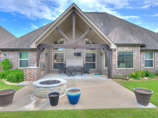 7605 E 82nd Pl, Owasso, OK 74055 - rear view of house with brick siding, a fire pit, a patio, and a shingled roof
