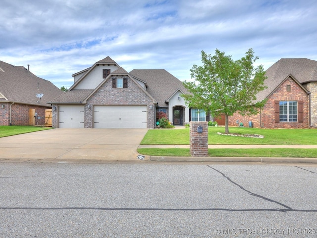 7605 E 82nd Pl, Owasso, OK 74055 - view of front of home featuring a front yard, driveway, a garage, brick siding, and a shingled roof