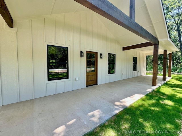 12443 Longboard Loop, Kingston, OK 73439 - property entrance featuring a patio area, board and batten siding, and a yard