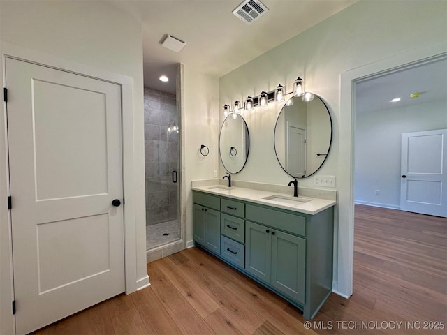 12443 Longboard Loop, Kingston, OK 73439 - full bathroom featuring double vanity, wood finished floors, a stall shower, recessed lighting, and baseboards