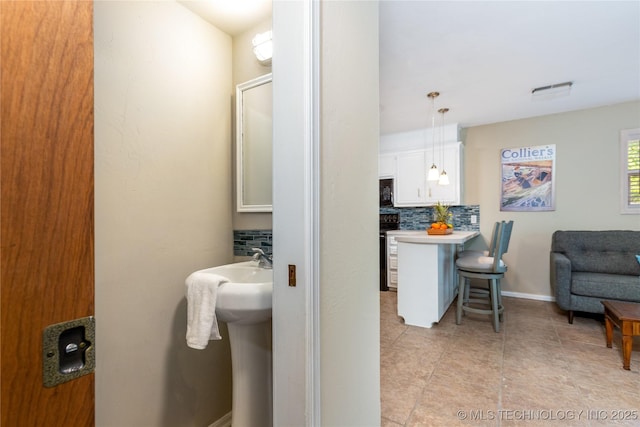 32075 Felts Ln, Afton, OK 74331 - bathroom featuring decorative backsplash, tile patterned floors, and baseboards