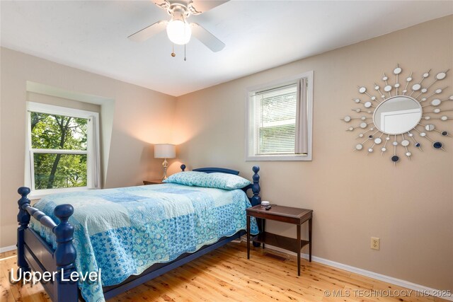 32075 Felts Ln, Afton, OK 74331 - bedroom featuring multiple windows, wood finished floors, baseboards, and ceiling fan