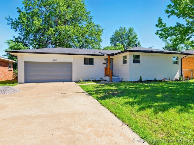 10931 E 4th Pl, Tulsa, OK 74128 - view of front facade with a garage, a front lawn, driveway, and brick siding