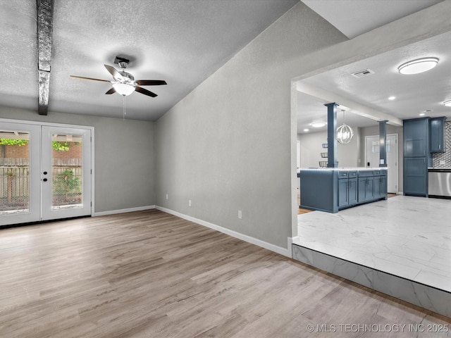 10931 E 4th Pl, Tulsa, OK 74128 - unfurnished living room with a textured ceiling, ceiling fan, light wood finished floors, baseboards, and french doors