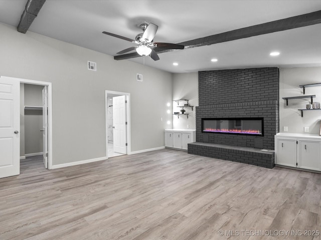 10931 E 4th Pl, Tulsa, OK 74128 - unfurnished living room with ceiling fan, beam ceiling, a brick fireplace, light wood-style flooring, and baseboards