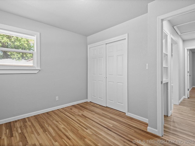 10931 E 4th Pl, Tulsa, OK 74128 - unfurnished bedroom featuring light wood-style flooring, baseboards, and a closet
