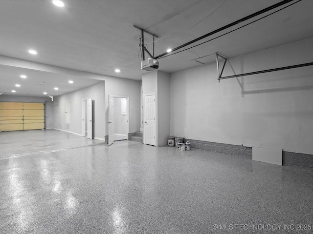 10931 E 4th Pl, Tulsa, OK 74128 - garage featuring a garage door opener, recessed lighting, and baseboards