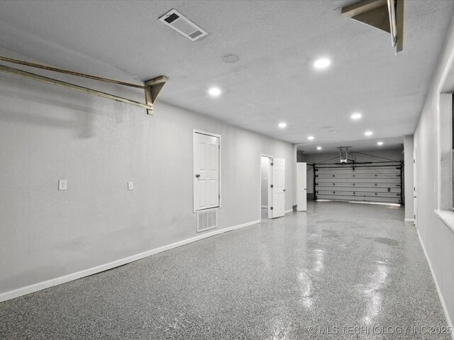 10931 E 4th Pl, Tulsa, OK 74128 - garage featuring baseboards and recessed lighting