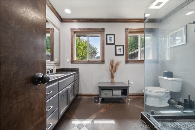 4341 E 56th Pl, Tulsa, OK 74135 - bathroom with toilet, vanity, baseboards, crown molding, and plenty of natural light