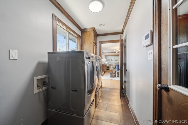 4341 E 56th Pl, Tulsa, OK 74135 - laundry room with ornamental molding, separate washer and dryer, cabinet space, baseboards, and tile patterned flooring