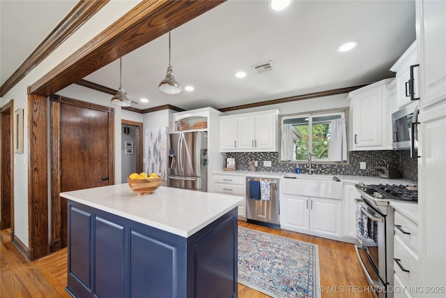 4341 E 56th Pl, Tulsa, OK 74135 - kitchen featuring appliances with stainless steel finishes, ornamental molding, white cabinetry, decorative backsplash, and light countertops