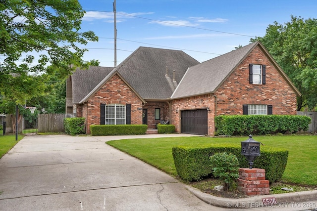 5506 E 110th Pl, Tulsa, OK 74137 - traditional home with a shingled roof, brick siding, an attached garage, and concrete driveway