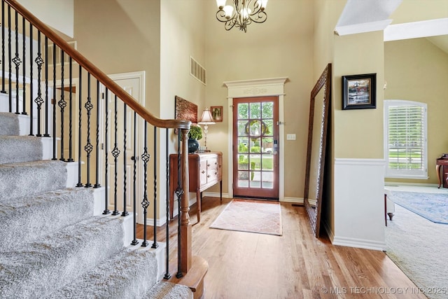 5506 E 110th Pl, Tulsa, OK 74137 - entrance foyer with a chandelier, wood finished floors, stairs, a towering ceiling, and baseboards