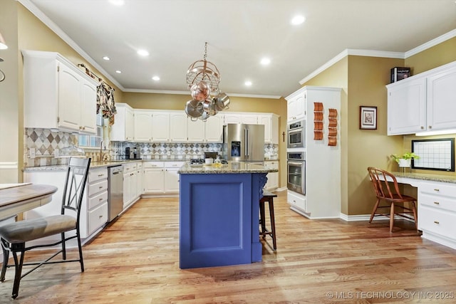 5506 E 110th Pl, Tulsa, OK 74137 - kitchen featuring stainless steel appliances, ornamental molding, white cabinetry, a kitchen island, and recessed lighting