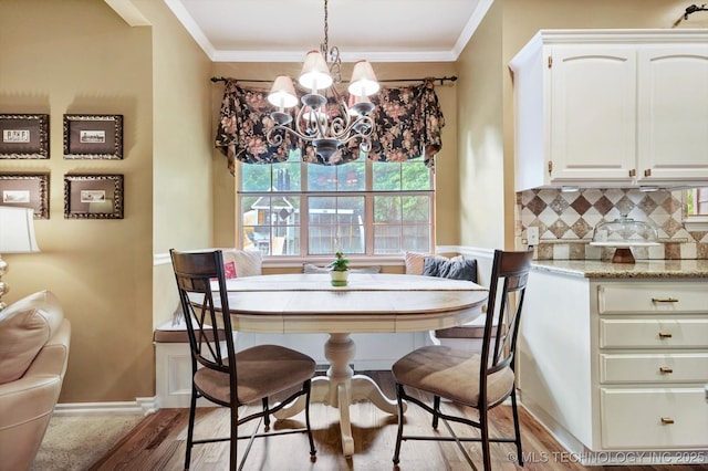 5506 E 110th Pl, Tulsa, OK 74137 - dining area with a chandelier, wood finished floors, ornamental molding, and baseboards