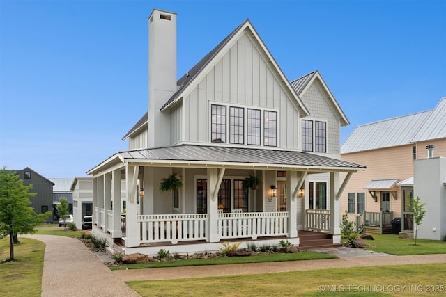 52 Redbud St, Carlton Landing, OK 74432 - modern farmhouse with a porch, board and batten siding, a chimney, metal roof, and a front yard