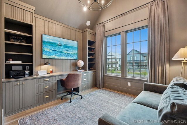52 Redbud St, Carlton Landing, OK 74432 - office featuring built in shelves, light wood-type flooring, built in desk, vaulted ceiling, and a chandelier