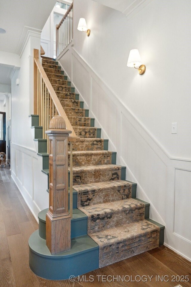 52 Redbud St, Carlton Landing, OK 74432 - stairway with a decorative wall, wood finished floors, a wainscoted wall, and ornamental molding