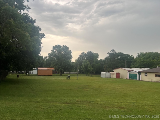 101 N 3rd St, Hartshorne, OK 74547 - view of grassy yard featuring a garage