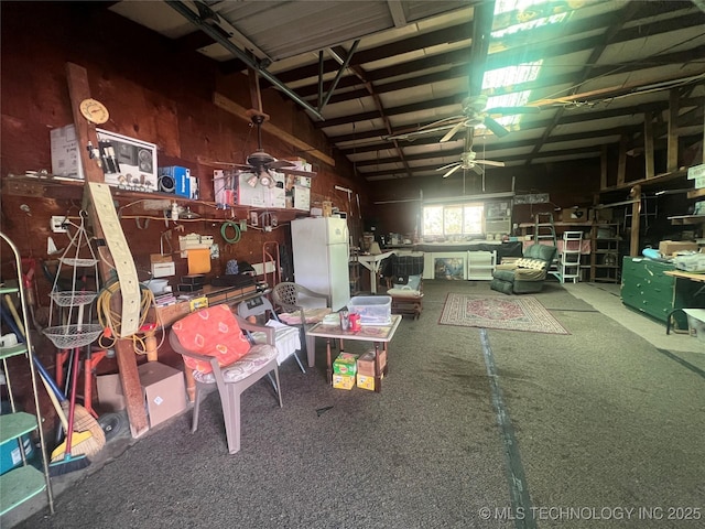 101 N 3rd St, Hartshorne, OK 74547 - garage with a ceiling fan, freestanding refrigerator, and a workshop area