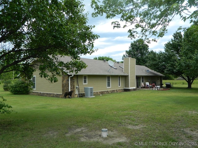 173 County Road 5305th Rd, Wynona, OK 74084 - rear view of property with a lawn, central AC, stone siding, a patio area, and a chimney