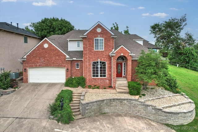 6007 E 76th Ct, Tulsa, OK 74136 - traditional-style house with brick siding, central air condition unit, an attached garage, concrete driveway, and a shingled roof