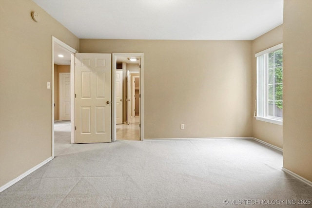6007 E 76th Ct, Tulsa, OK 74136 - unfurnished bedroom with light colored carpet and baseboards