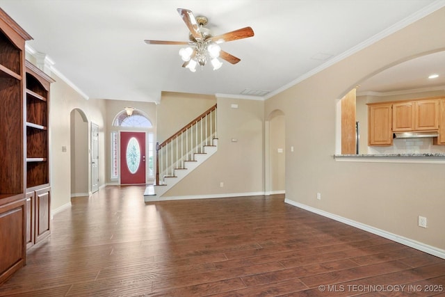 6007 E 76th Ct, Tulsa, OK 74136 - entryway with a ceiling fan, dark wood-style floors, arched walkways, crown molding, and baseboards