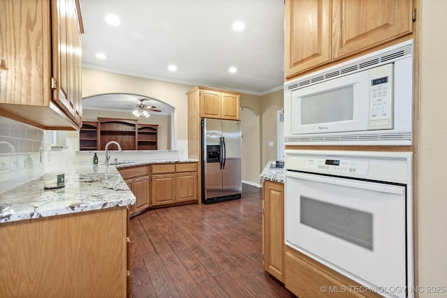 6007 E 76th Ct, Tulsa, OK 74136 - kitchen with white appliances, crown molding, dark wood-style flooring, a sink, and arched walkways