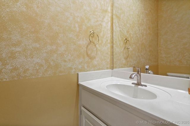 6007 E 76th Ct, Tulsa, OK 74136 - bathroom featuring vanity, wallpapered walls, and toilet