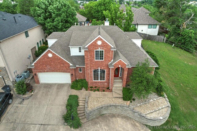 6007 E 76th Ct, Tulsa, OK 74136 - traditional-style home featuring a shingled roof, brick siding, an attached garage, concrete driveway, and a chimney